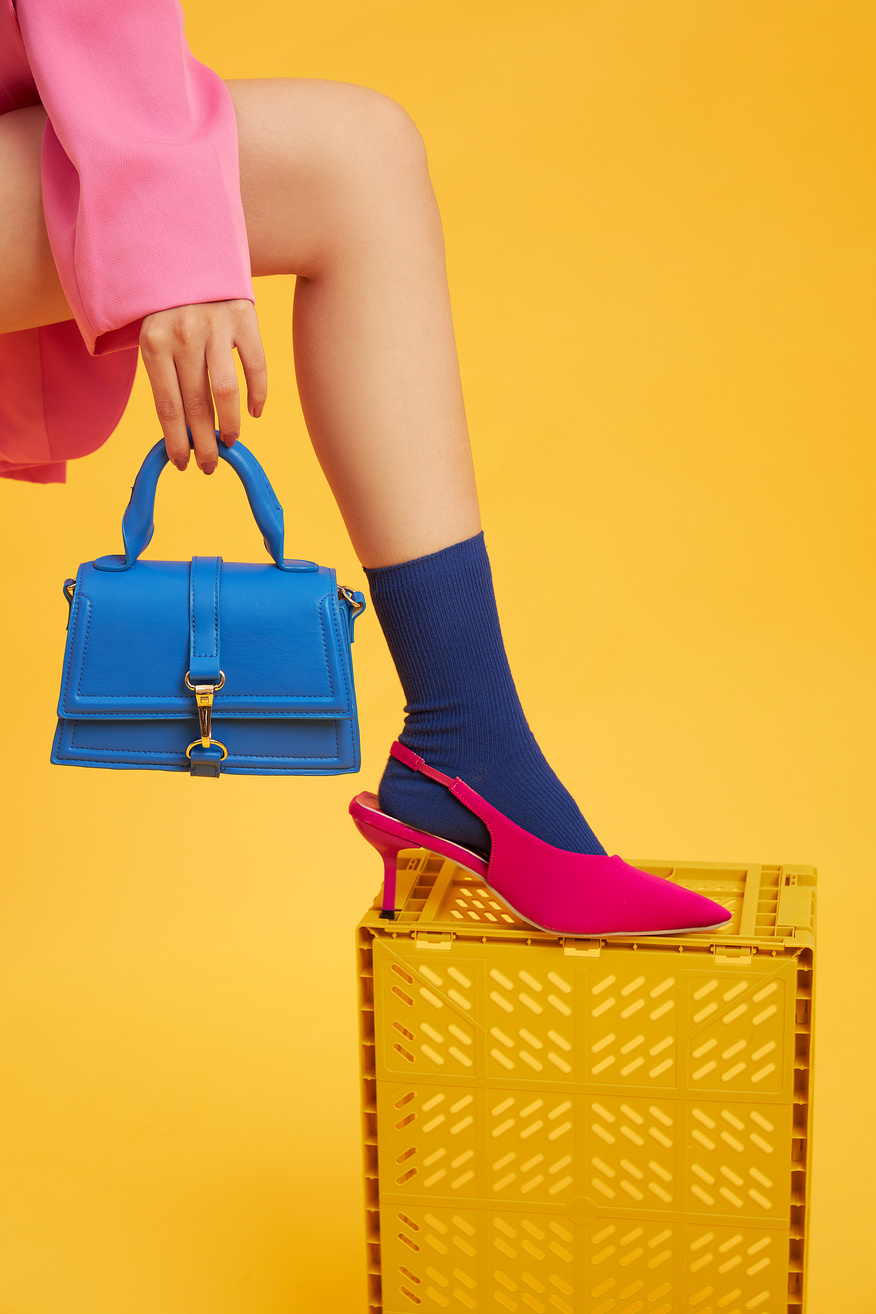 Stylish Woman in Pink Shoe, Blue Socks, and Bag