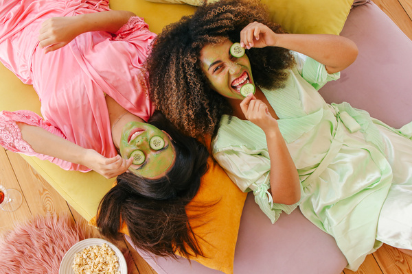 Young Girls having Fun with Cucumbers for Skincare